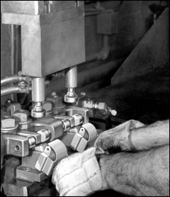 A Case History: Joining a piece of metal to itself is always tough. This job was done with an Equa-Press holder - two at a time. Lower clamp faces, carrying current, contact parts near the weld areas to avoid current bypassing weld projections. Two standard swivel tips make four welds, two per part.